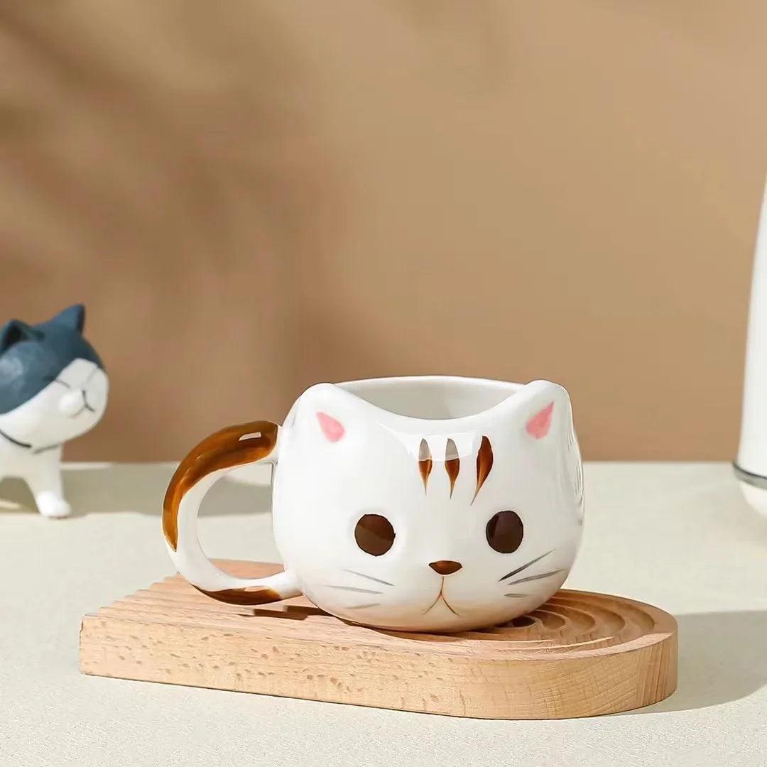 Cat ceramic mug, white with brown ear and face spots, on wooden base