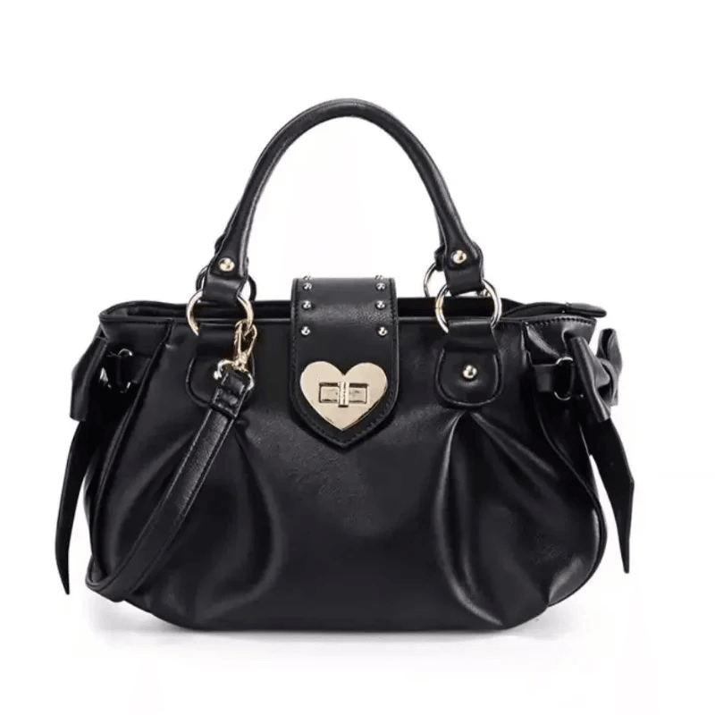 Black heart-lock handbag with dual top handles, front heart emblem, and dangling ribbon ties.