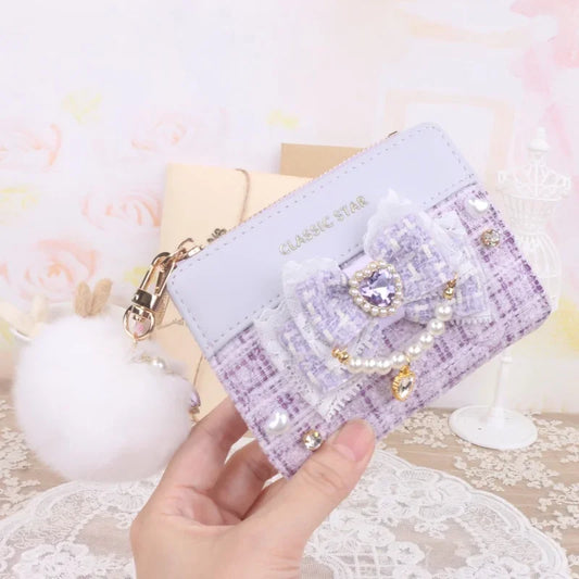 Purple quilted wallet with heart charm bow, pearl trim, and gold-tone zipper