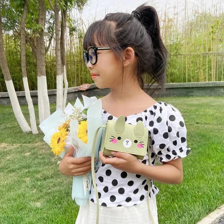 Children's bunny crossbody bag, light green with bunny face front and crossbody strap