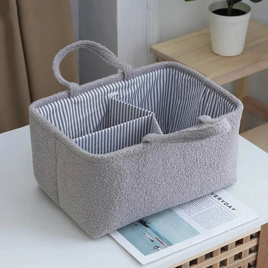 Gray diaper caddy organizer bag with striped interior, 3 compartments, and side handle