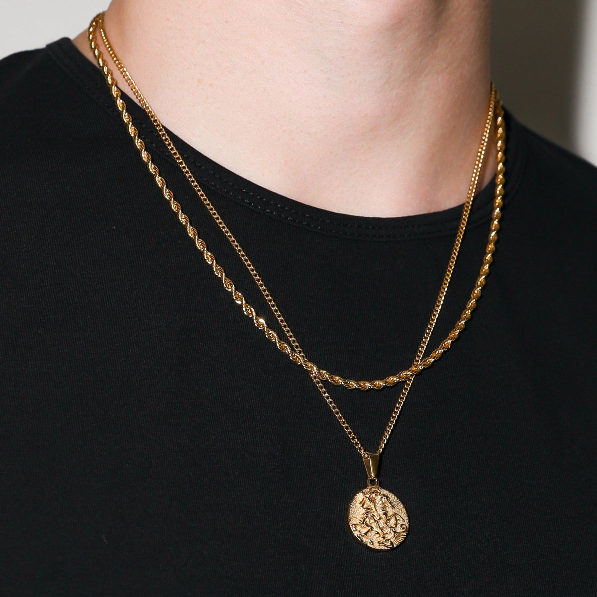 Gold coin pendant necklace worn with pendant centered on the chain