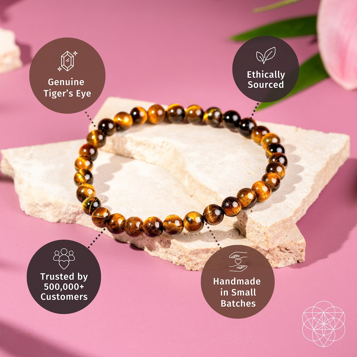 Tiger’s eye bead bracelet on white stone with badge icons for quality