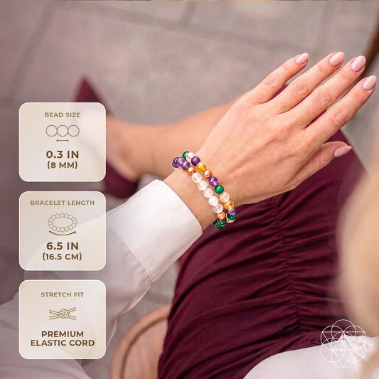 Crystal bead bracelet on wrist with multicolor round stones in purple, green, and orange