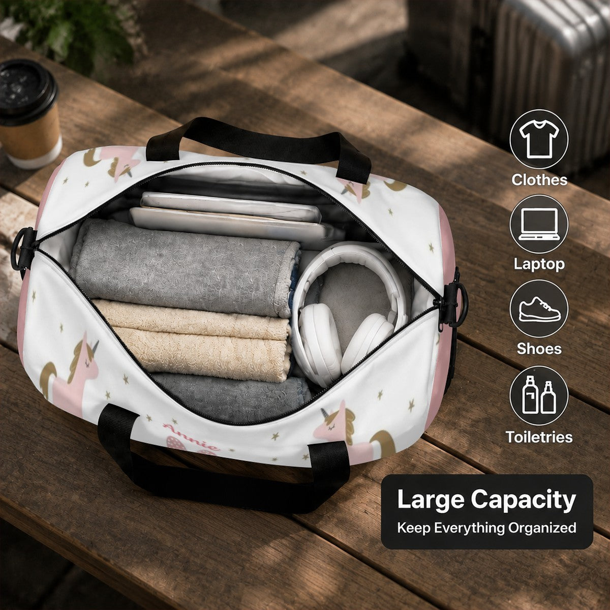 Unicorn duffel bag open with rolled clothes and headphones inside
