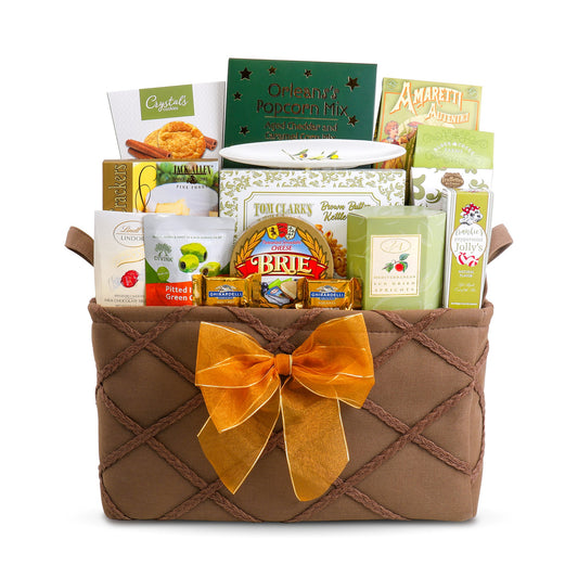 Savory gift basket wrapped in brown fabric with orange ribbon and assorted packaged snacks.