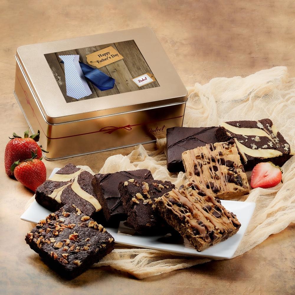Gift tin labeled Happy Father's Day with brownie assortment and strawberry garnish