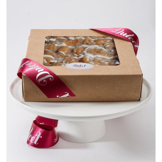 Cheese crumb cake in gift box with clear window, crumb topping visible