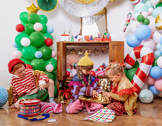 Balloon-filled birthday scene with green, red and blue balloon clusters around kids