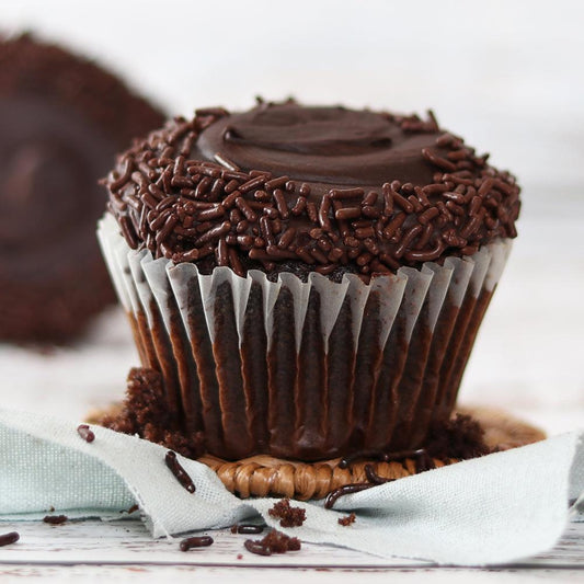 Chocolate cupcake with dark chocolate sprinkles frosting and crumbled base
