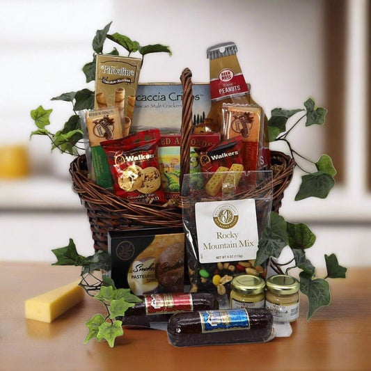 Snack gift basket with woven wicker base, assorted packaged snacks and green vine leaves.