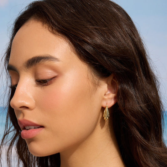 Gold abstract hoop earrings with textured teardrop design