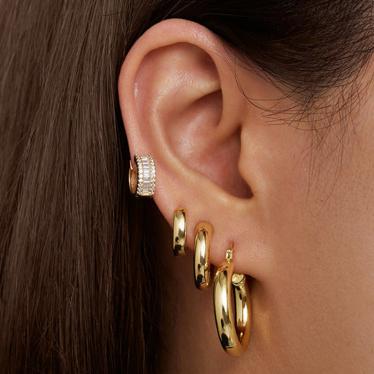 Gold tube hoop earrings with small hoop and stud earrings, worn on ear