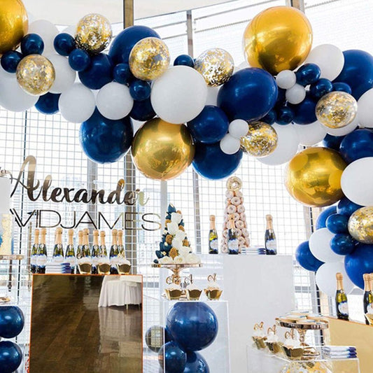 Navy and white balloon garland with gold accent balloons in a curved arch