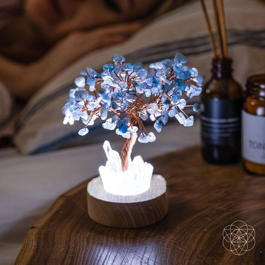 Aquamarine-style crystal tree lamp on wooden base with lit crystal centerpiece