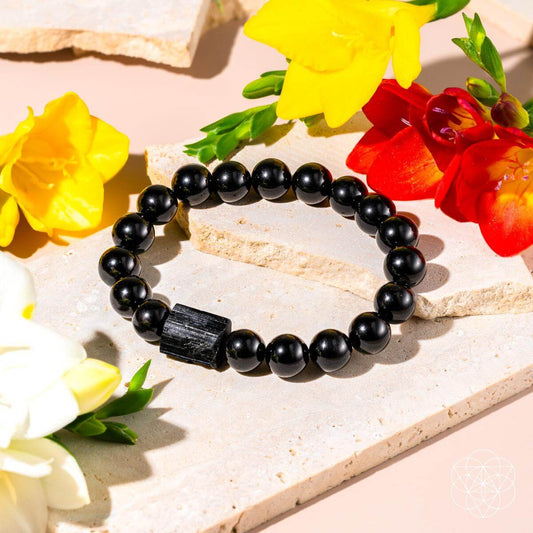Black round bead bracelet featuring a dark rectangular centerpiece charm