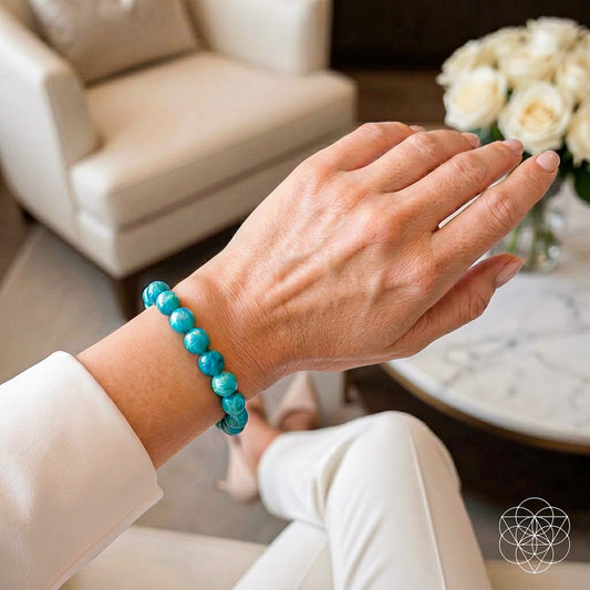 Blue amazonite bead bracelet on an open hand, round turquoise stones on wrist.