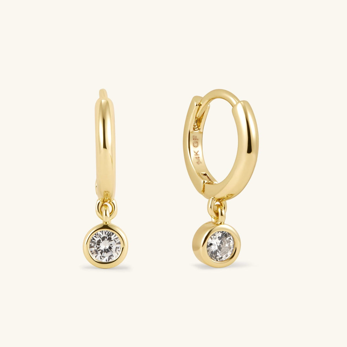 Pair of gold-tone hoop earrings with round bezel-set diamond dangles
