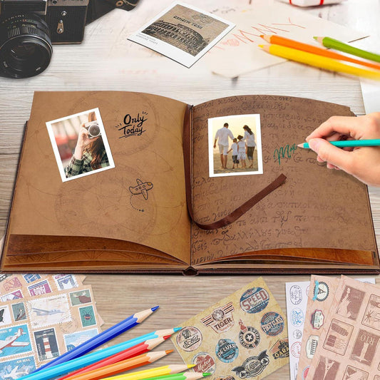 Zodiac memory journal open with brown pages, photo corners, handwritten notes, and pencils