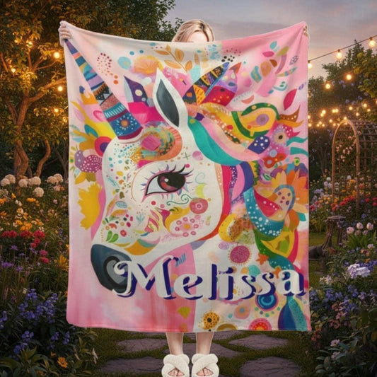 Pink unicorn fleece throw blanket with colorful unicorn face and 'Melissa' name