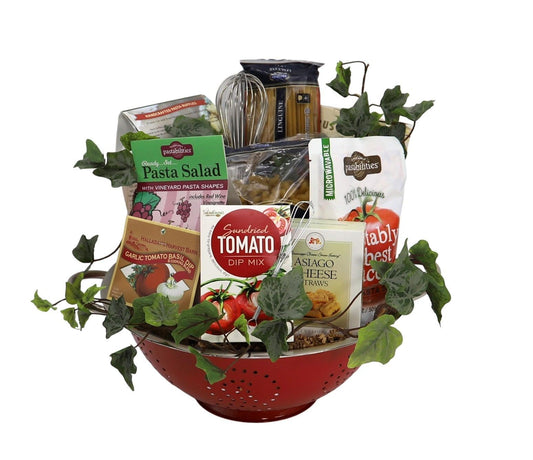 Gift basket in red colander with tomato dip, Asiago cheese, pasta salad, and crackers