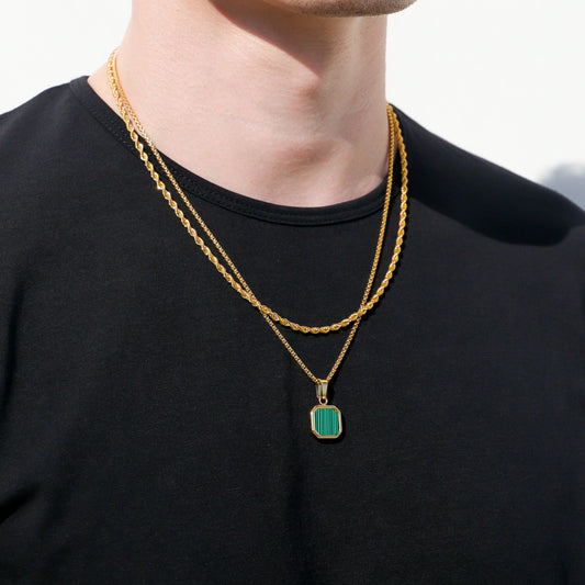Gold-tone layered necklace with turquoise rectangular pendant stone and gold chain