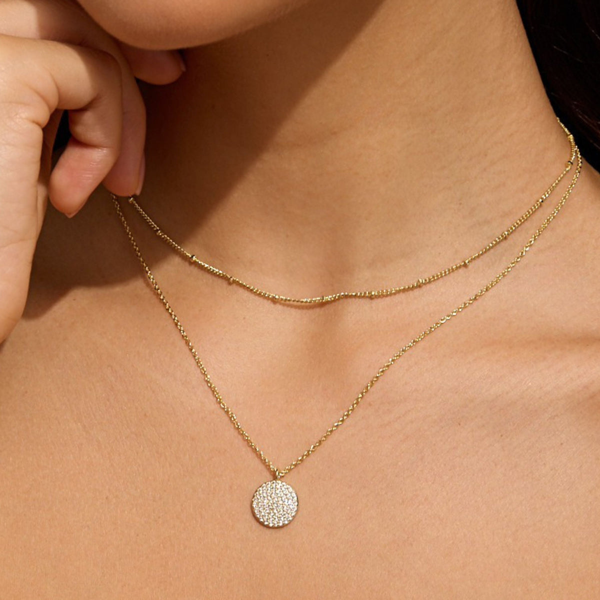 Pave disc necklace with layered gold chains and round pavé pendant