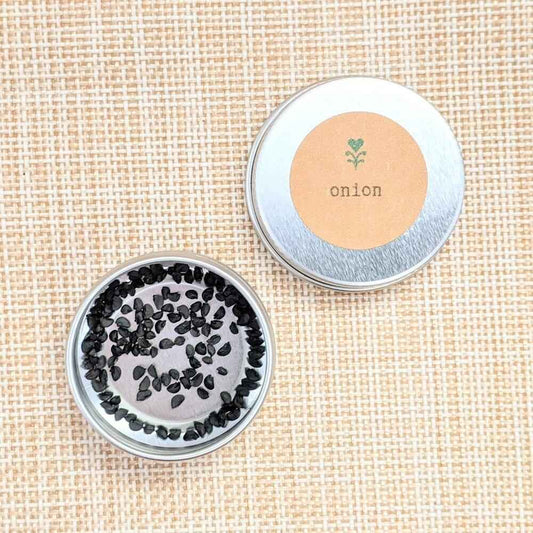 Onion seed tin with black seed pile and label