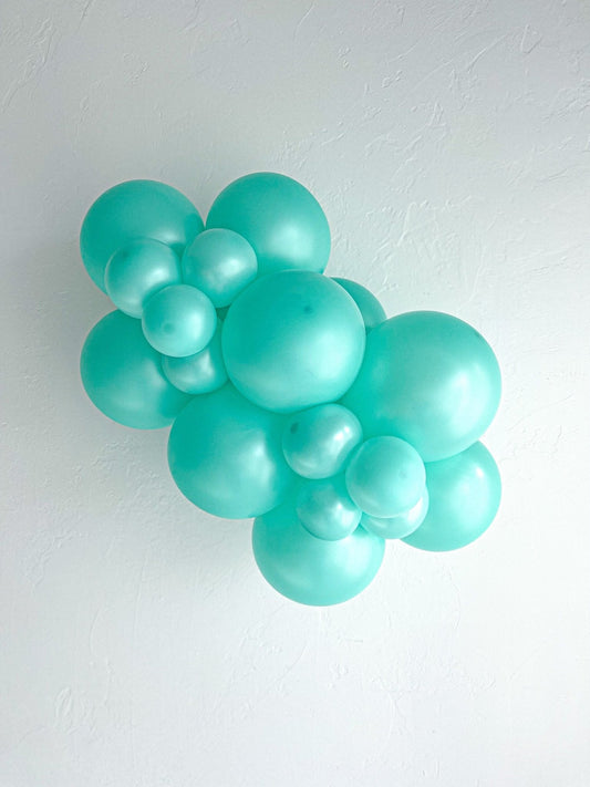 Sea foam latex balloon cluster with multiple round balloons and ribbon neck