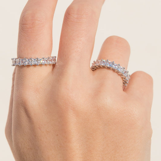 Silver CZ eternity band ring on hand, square-cut stones along the top