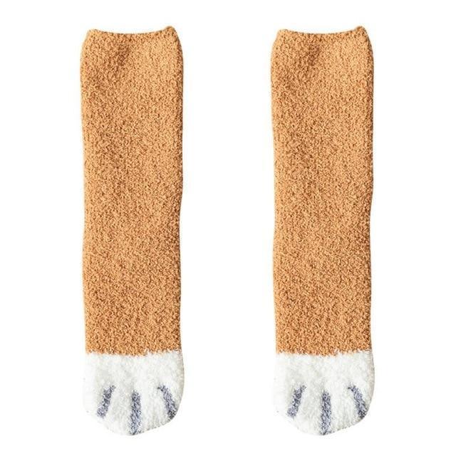 Tan knit socks with white toe panel and black cat-face pattern