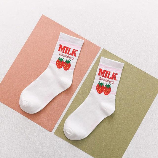 Pairs of white socks with red strawberry “MILK” text cuffs