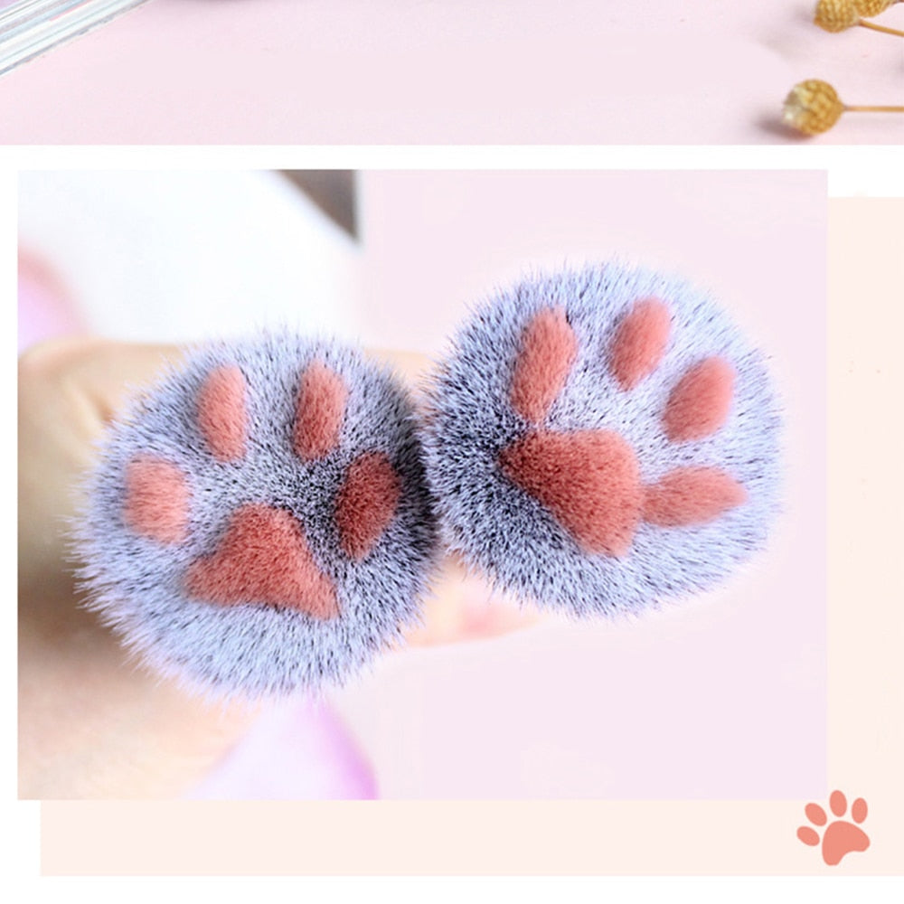 Cat paw makeup brushes with fuzzy blue bristles and orange paw pad markings