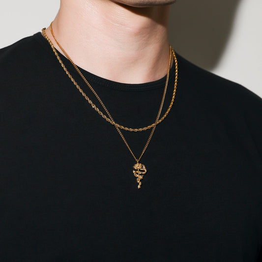 Gold rope chain necklace with serpent rose pendant, worn on neckline