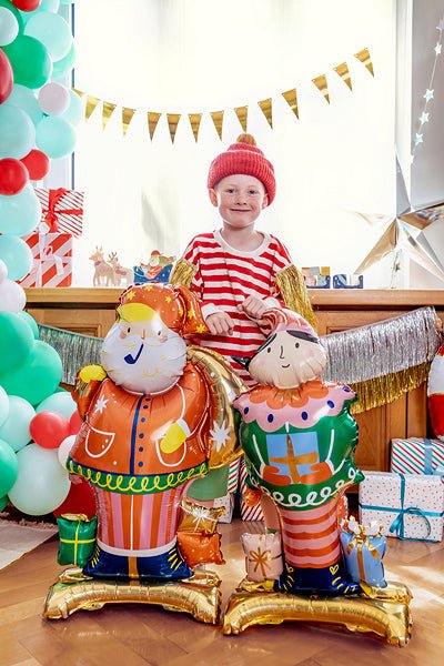 Standing Santa foil balloon in orange coat with white beard, beside festive balloons