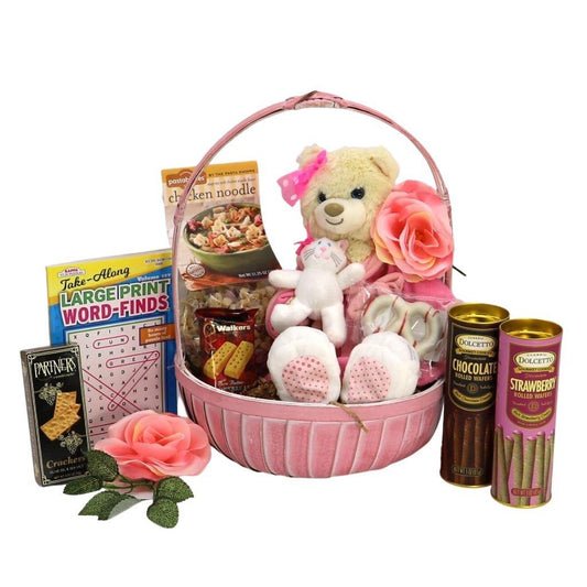 Pink gift basket with Care Bear plush, rose accents, and rolled wafer drinks