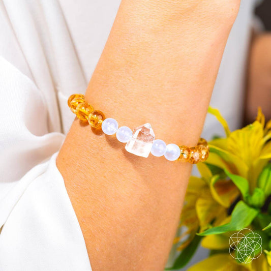 Amber and white beaded bracelet worn on wrist with clear crystal detail