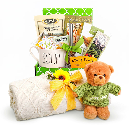 Cozy gift box with mug, quilted blanket, plush teddy bear in green sweater and bow