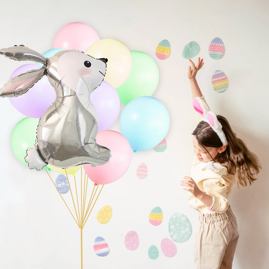 Rabbit foil balloon with pastel latex balloon bouquet and gold strings, plus a child reaching up