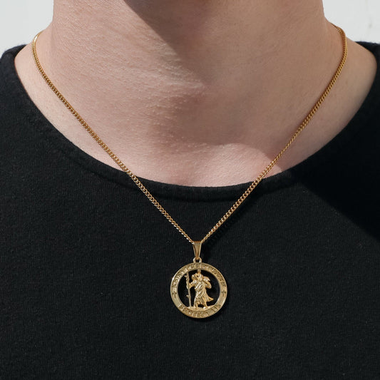 Gold curb chain necklace with round Saint Christopher medal pendant, worn