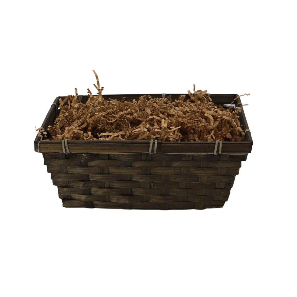 Wicker gift basket with brown shredded filler and rustic twigs