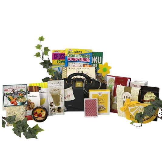 Care package gift basket with assorted snacks and tea items, black tote bag