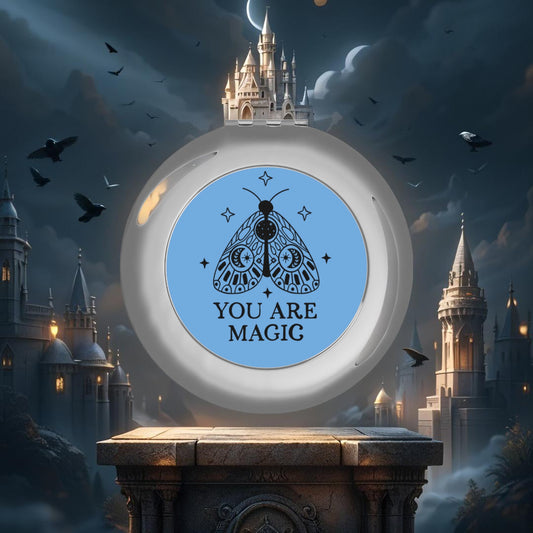 Silver glossy compact travel mirror with “YOU ARE MAGIC” blue moth design on round face