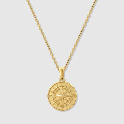 Gold compass pendant necklace with round medallion and compass rose on chain
