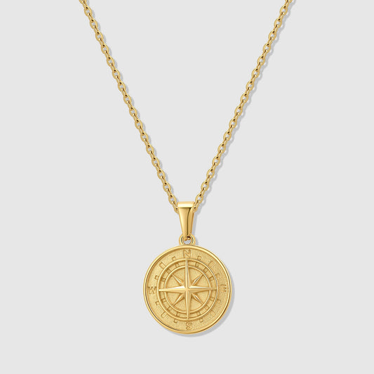 Gold compass pendant necklace with round medallion and compass rose on chain