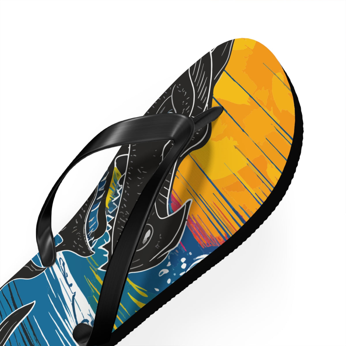 Close-up of flip flop top with dragon graphic on yellow/orange footbed and black strap.