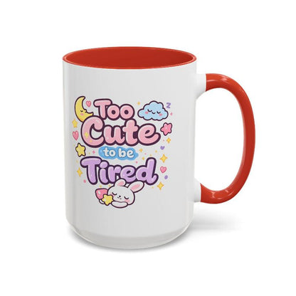 White mug with red rim and handle, “Too Cute to be Tired” text and bunny.