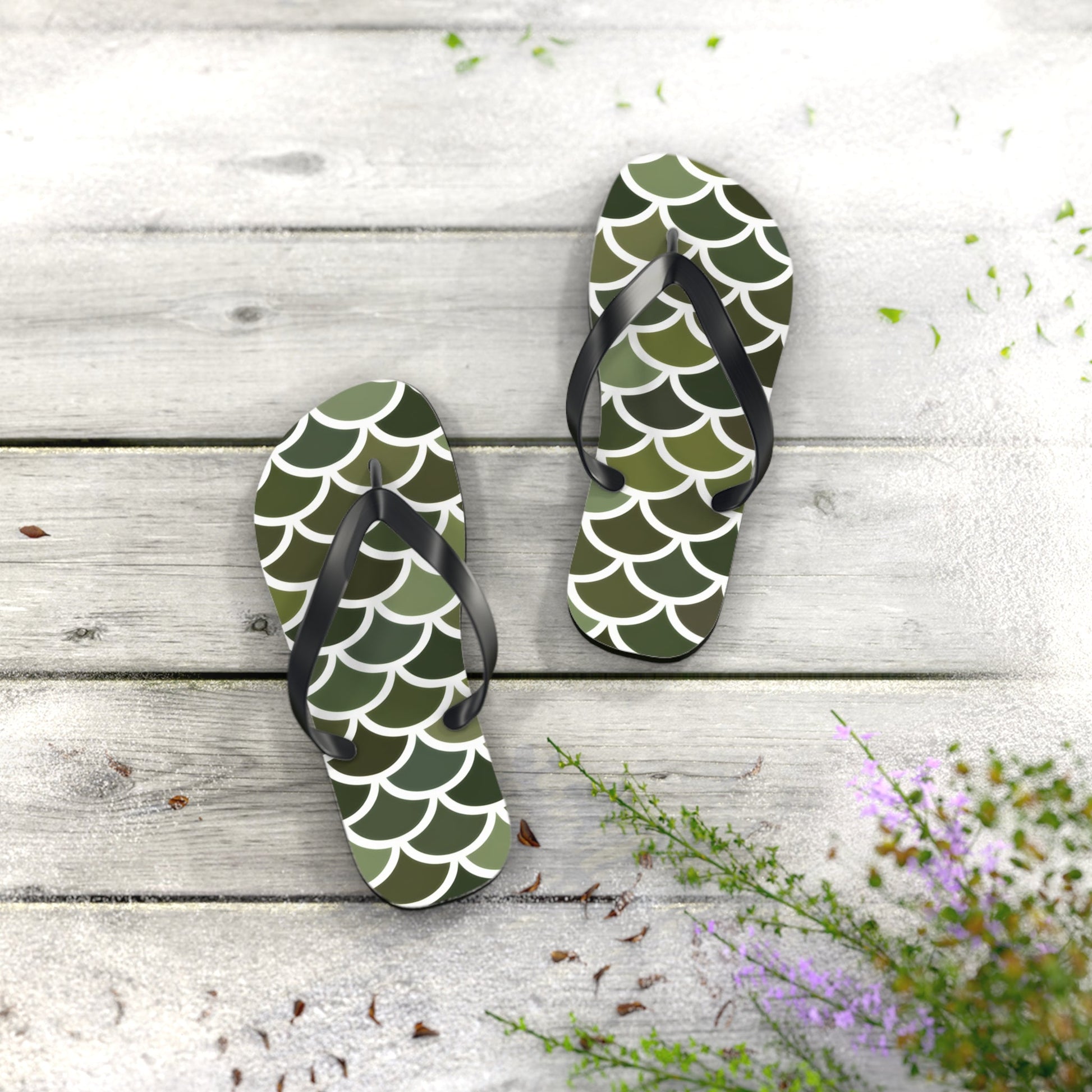 Green flip-flops with white scale pattern and black thong straps, standing upright