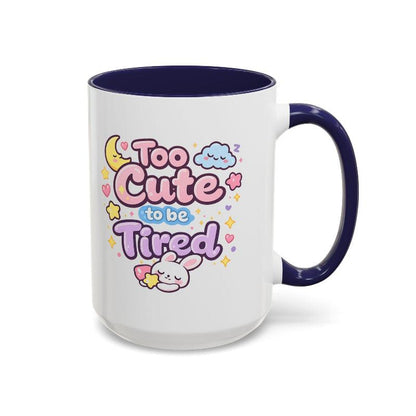 White mug with navy rim and handle, kawaii bunny “Too Cute to be Tired” front design.