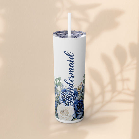 White skinny tumbler with blue and white floral design, script custom name, and light blue straw.